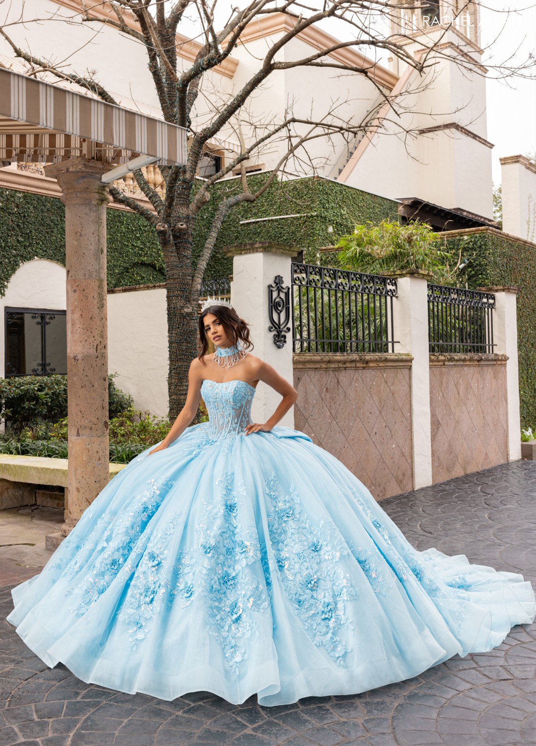 Blue quinceañera dress with structured bodice, crystal beading, and multi-tiered tulle layers